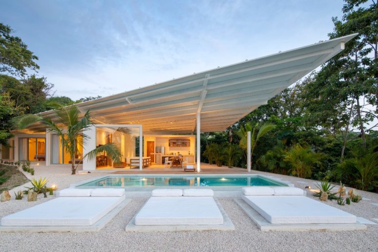 The indoor spaces are opened to outdoors, there's a poll and several outdoor beds