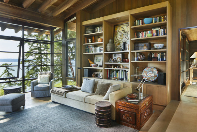 There's an open storage wall unit and a carved chest for storage