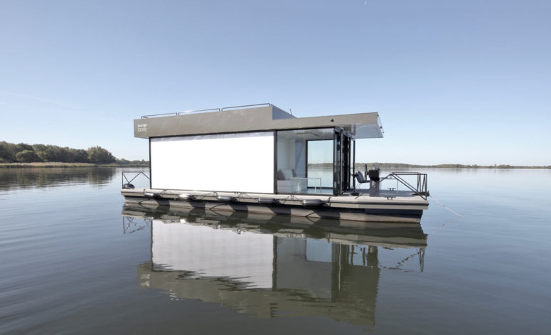 The exterior is done in white and grey, with much glazing and an opaque shell