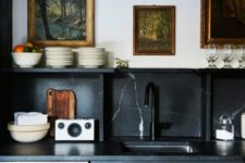 04 a black vintage-inspired kitchen with a black marble backsplash and countertops for a refined touch