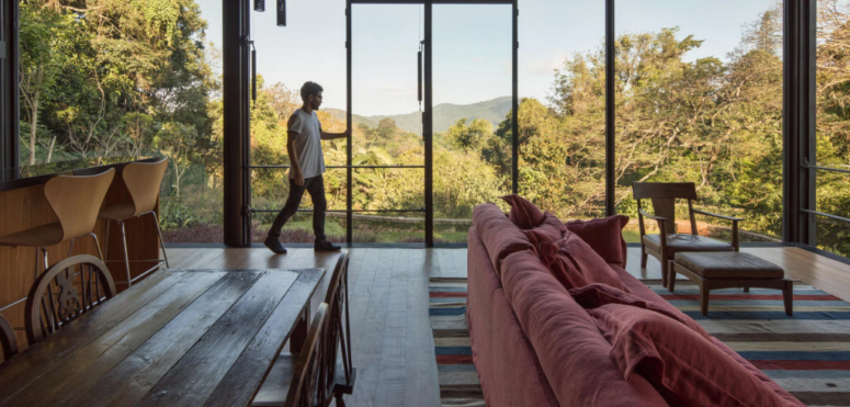 The indoors is fully opened to outdoors, there are glazed walls to enjoy the views of the rainforest