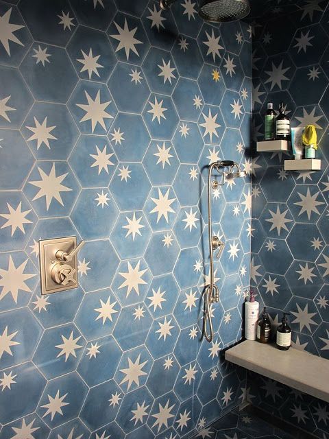 a chic bathroom clad with navy and brass star tiles looks very bold and very dreamy with these celestial tiles