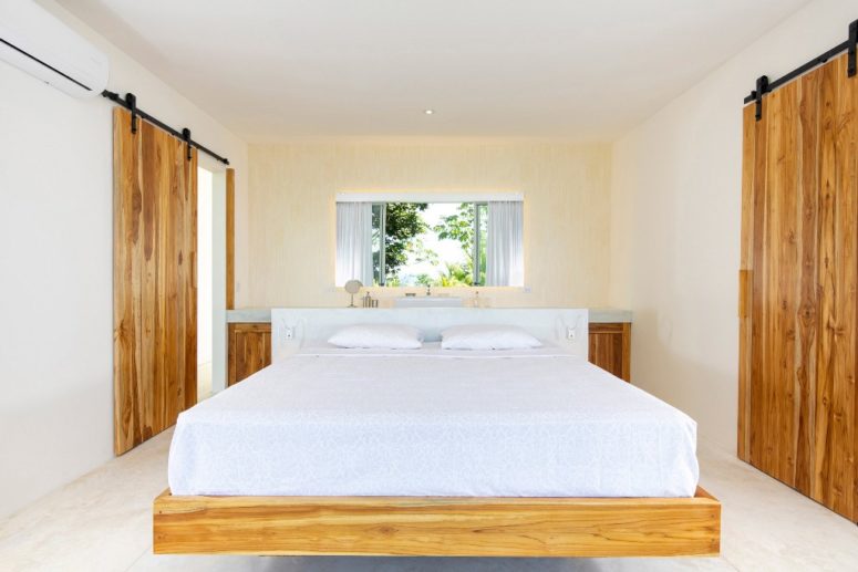 The bedroom are decotated all-neutral, with a floating bed and a vanity table