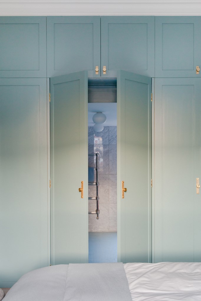The master bathroom is hidden behind a set of the doors