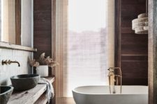 06 This bathroom features much natural wood, tiles, a white stone tub and even some views