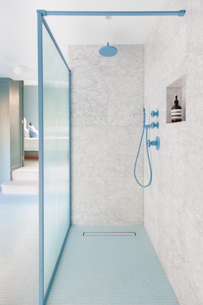 The master bathroom continues the blue palette of the master bedroom