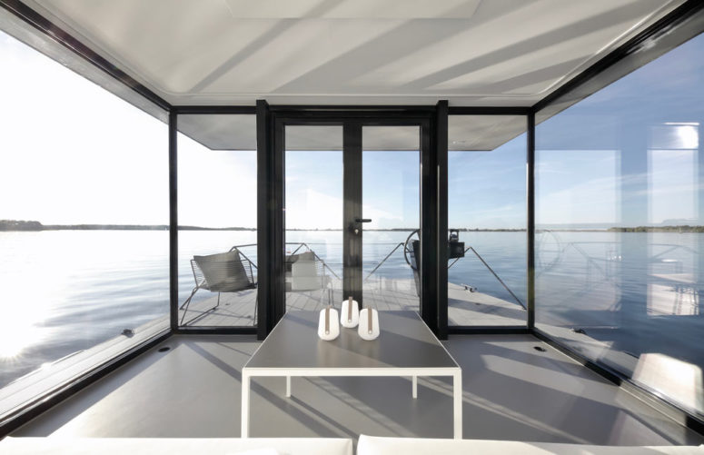 The living room feels almost outdoorsy as it's fully glazed, with much natural light and cool views