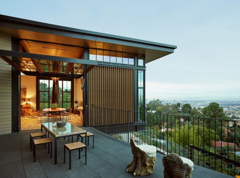 This outdoor space is a dining zone with wicker furniture and whimsical chairs