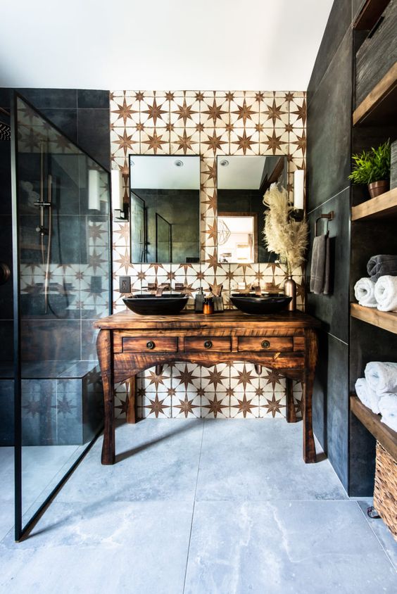 a refined bathroom with a white star tile accent wall and dark matte tiles plus a refined vintage wooden vanity