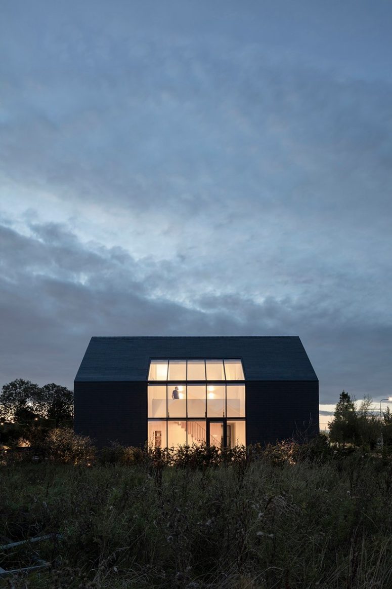 The large glazings are a source of natural light inside and they connect to outdoors