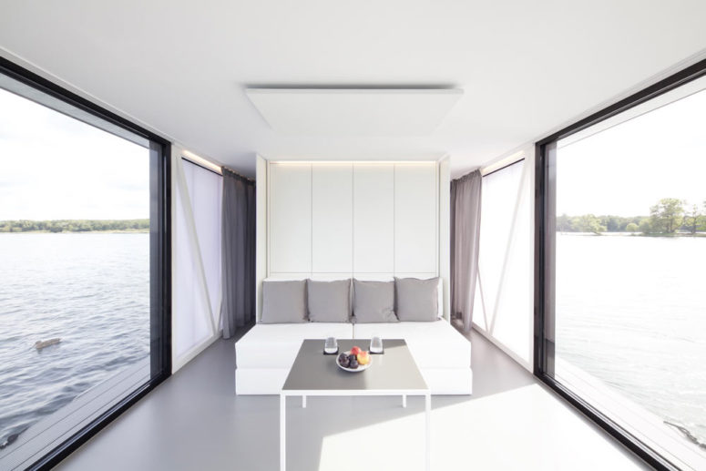 There's a small sofa with pillows, built-in lights and a coffee table