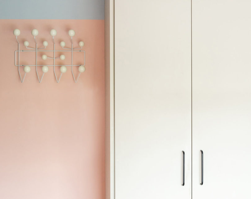 The storage unit is neutral, it stands out on a color block pastel wall