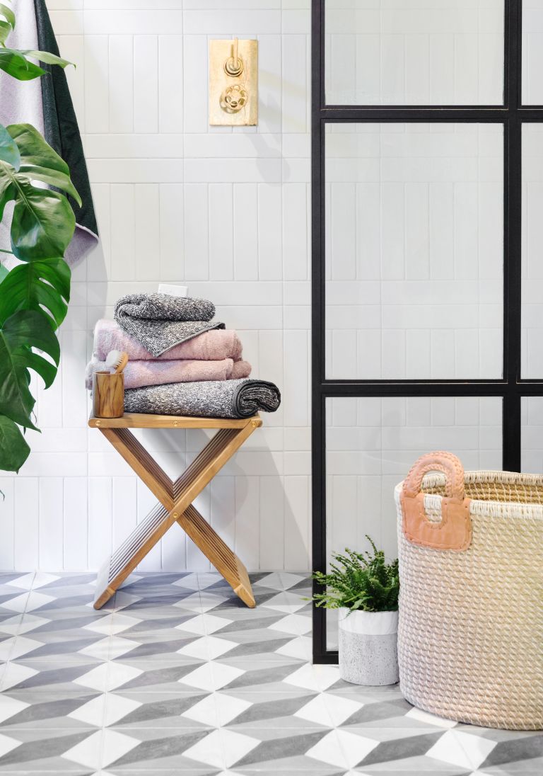 a small wooden stool is a nice storage unit, you can also sit on it, so get a folding one for your bathroom