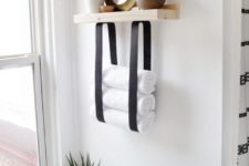 13 a wood and leather strap towel shelf will let you store not only towels but also decor and accessories