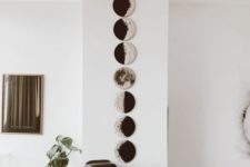 22 a wall art with moon phases is very lovely and looks modern and bold, perfect for a boho space