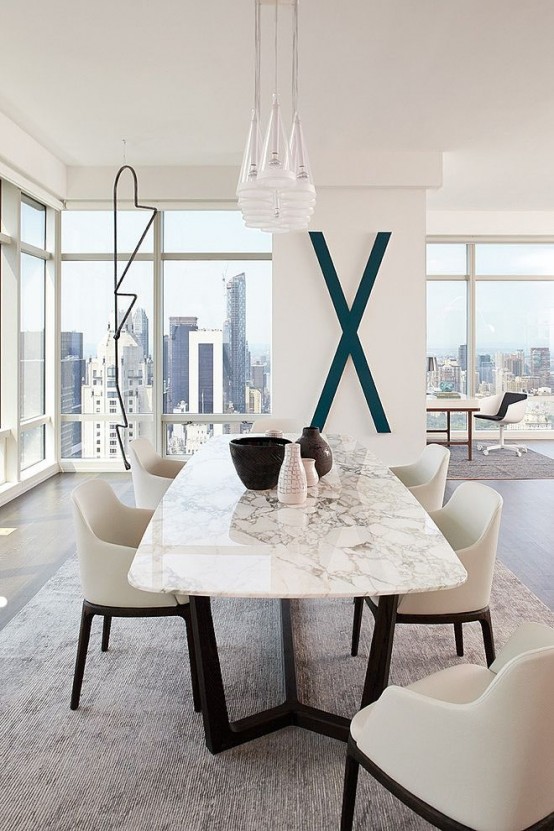 a contemporary luxurious dining table with a black base and a white marble tabletop for ultimate chic