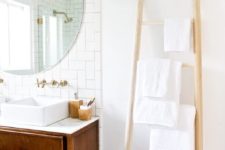 23 a simple wooden ladder with some towels is a cool space-saving towel storage idea for every kind of bathroom
