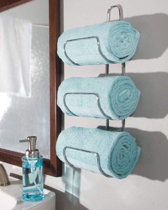a stylish wall-mounted towel holder attached by the sink is a life changer that will save much space