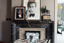 25 a whimsical fireplace clad with neutral stone and black marble plus artworks and animal print stools