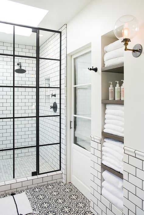 built in shelves in the wall allow storing a lot of towels and bathroom stuff comfortably and without clutter