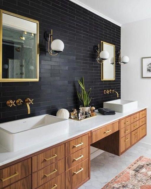 a contemporary bathroom with a black accent wall clad with skinny tiles feels bold and the wall adds depth