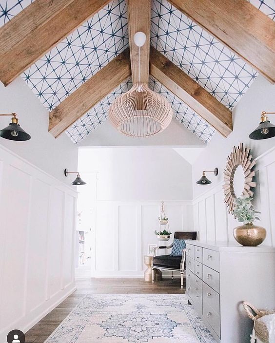 a stylish entryway with a printed wallpaper ceiling with wooden beams looks more unusual and more modern