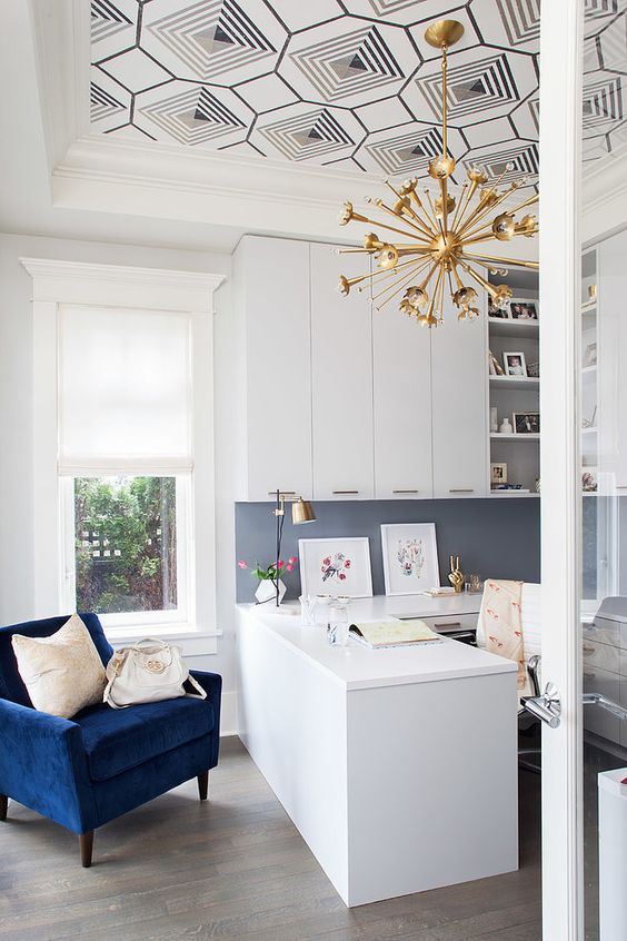 a stylish mid-century modern home office with a graphic wallpaper ceiling that brings pattern to the room