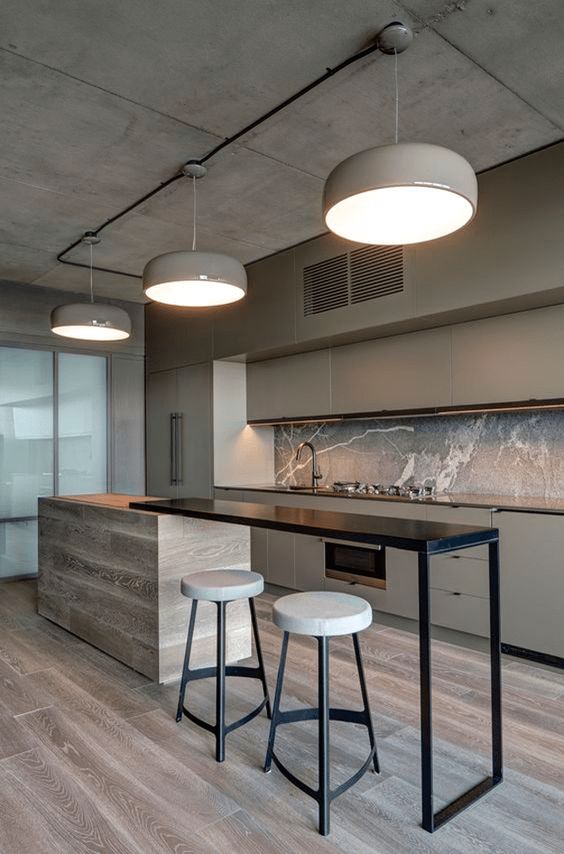 an ultra-minimalist earthy kitchen accented with a sleek black bar space and tall stools with black legs