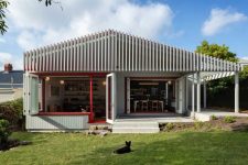 01 This ultra-modern home extension features mid-century modern interiors and lots of cedar in decor