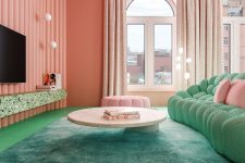 a glam living room with pink walls