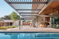There’s a pergola roof that extends the living room outdoors to the pool