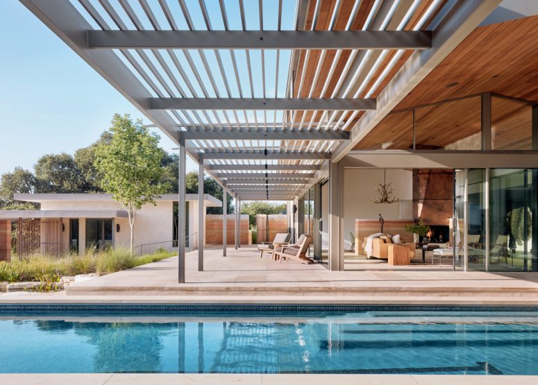 There's a pergola roof that extends the living room outdoors to the pool