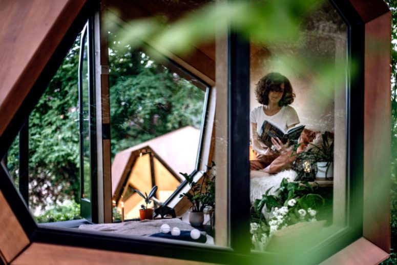 The little cabin features several irregular windows to fill it with natural light