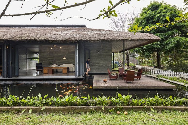Each part of the house can be opened to the pond and outdoors and there's a comfy terrace with wooden furniture under the roof