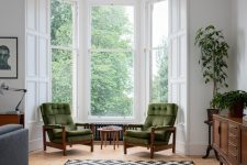 04 There’s a bay window with a couple of green chairs, which is a great conversation space or a reading one