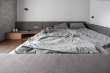 08 The bedroom is very minimal, done in white and grey, with stained wooden items