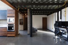 09 The furniture is dark and contemporary and you can see exposed brick walls here and there