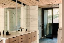 10 A combination of wood, marble and glass turns the bathroom into a soothing and welcoming space