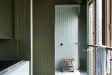 10 Another bathroom shows off neutral and green tiles that match sage green wood