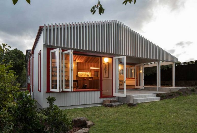 What makes this extension exterior special is a cool wooden screen that covers it all