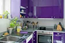 a bold violet kitchen with metal countertops and white knobs is a stylish and super catchy idea