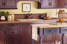 an elegant aubergine kitchen with terracotta tile countertops and a matching purple kitchen island with a light wood countertop