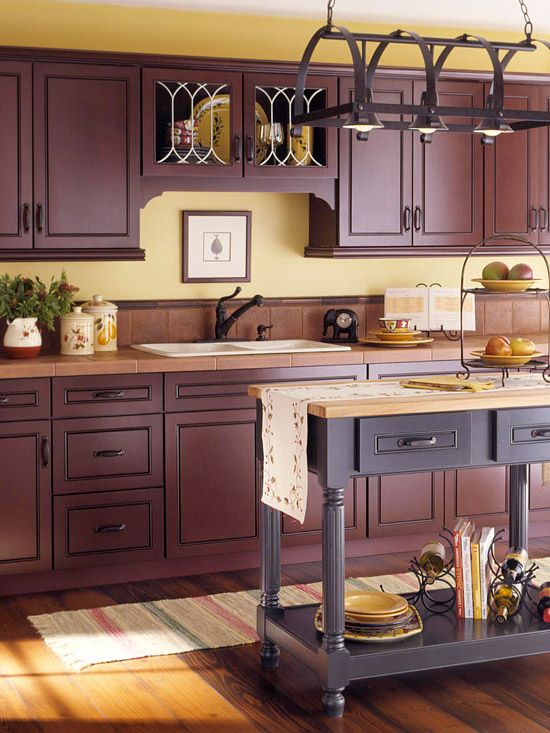 an elegant aubergine kitchen with terracotta tile countertops and a matching purple kitchen island with a light wood countertop