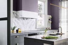 an ultra-modern kitchen with grey cabinets, white stone countertops and a backsplash and deep purple walls