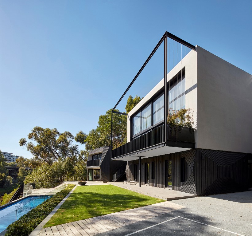 This contemporary house with an extension and a pool was built by an architect and a designer for themselves and their kids