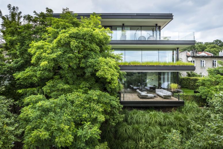 This contemporary riverside house features 700 square meters of space and expensive terraces on each floor