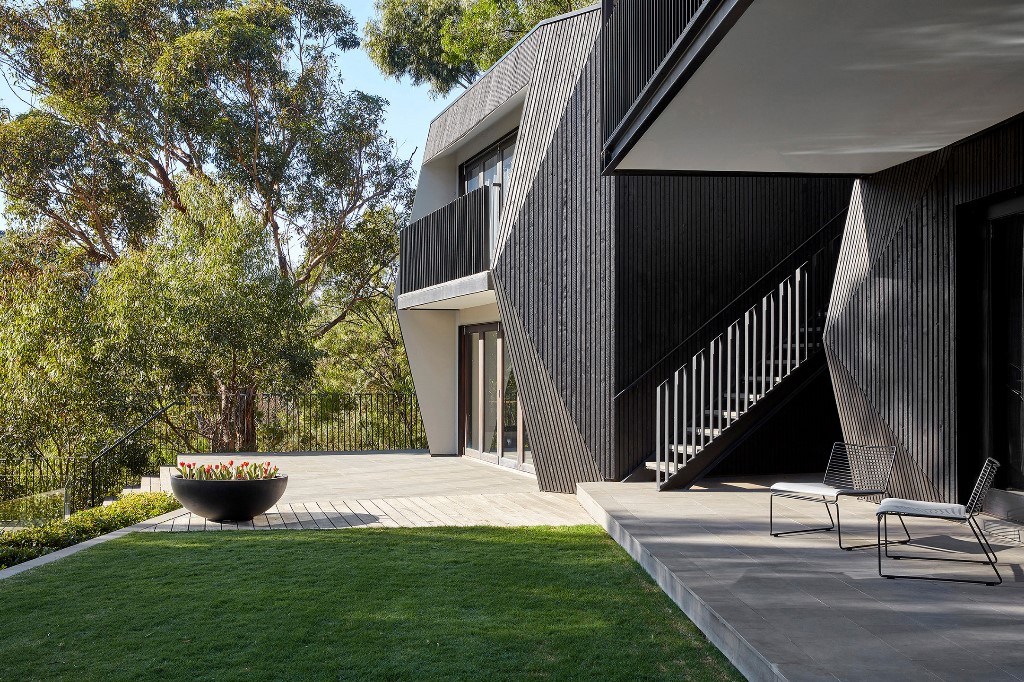 The house is clad with black cypress, concrete and blackened steel to give it an ultimate look