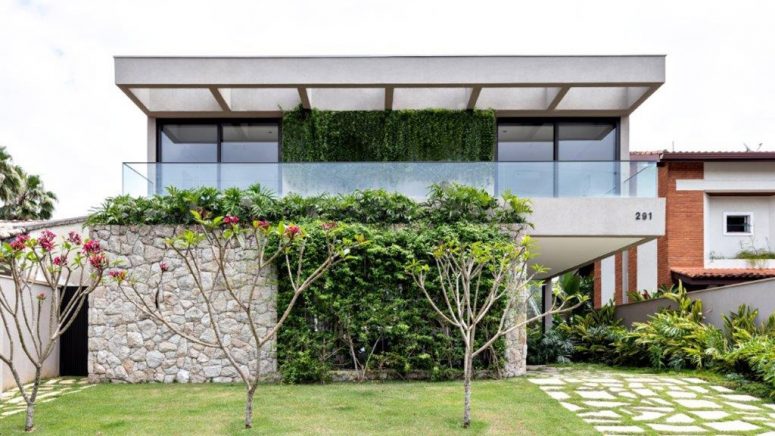 There's a lot of greeneryaround and on the house and a large minimalist balcony