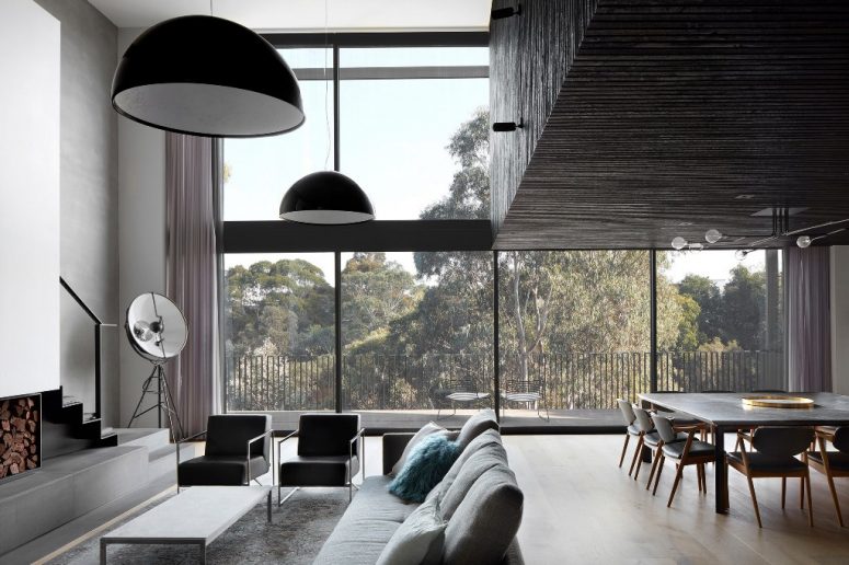 The main layout is a living room, dining room and kitchen with glazed walls and a fireplace