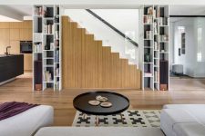 04 The minimalist staircase features some hidden storage units for more functionality